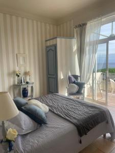 a bedroom with a bed with a view of the ocean at Toi & Moi in Sainte-Maxime
