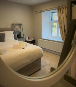 a bedroom with a bed and a window at The Marton Arms in Ingleton 