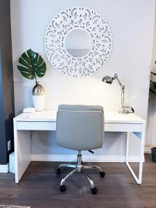 a white desk with a chair and a mirror at *NEW: Stylish Wortley 1BR Suite in London