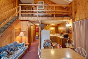 a kitchen and living room in a log cabin at Buckhorn in Iron River with Sauna Fish and Hike! in Iron River