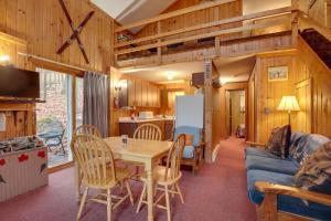 a kitchen and living room with a table and a refrigerator at Iron River Vacation Rental with Ski Slope Views! in Iron River