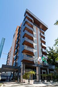 a building with balconies on the side of it at Hotel Flat Petras Residence in Curitiba