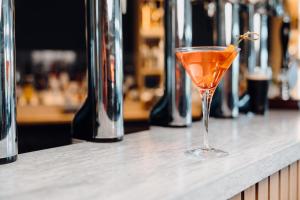 an orange drink in a glass sitting on a counter at The Dunes in Tenby