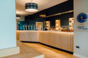 a bar in a restaurant with a counter at The Dunes in Tenby