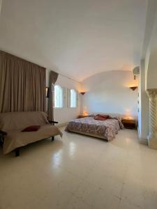a large bedroom with two beds and two windows at Blue Beach Hostel in Soliman
