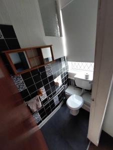 a small bathroom with a toilet and a sink at Captivating 1-Bed Apartment in Blackpool in Blackpool