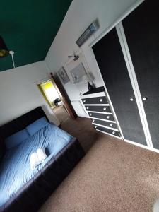 a bedroom with a bed with a cat laying on it at Captivating 1-Bed Apartment in Blackpool in Blackpool