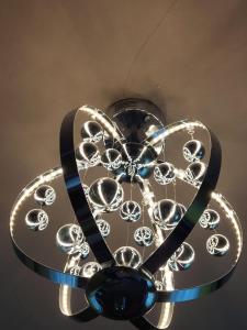 a glass sculpture of a flower on a ceiling at Captivating 1-Bed Apartment in Blackpool in Blackpool