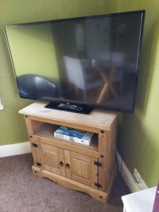 a flat screen tv on a wooden stand at Captivating 1-Bed Apartment in Blackpool in Blackpool