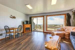 a living room with a couch and a table and chairs at Sanderling Sea Cottages, Unit 13 in Waldport