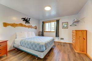 a bedroom with a bed and a wooden floor at Sanderling Sea Cottages, Unit 13 in Waldport