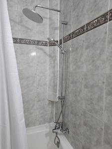 a bathroom with a shower with a shower curtain at Trudy's home in Nicosia