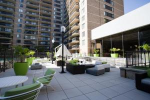 a patio with couches and tables and chairs at Elegant Condo for Business Travelers @Crystal City in Arlington