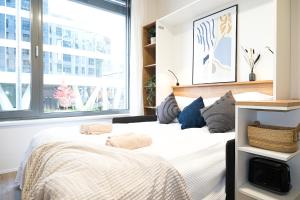 A bed or beds in a room at MyMozart Apartments Prague by Rentero Property
