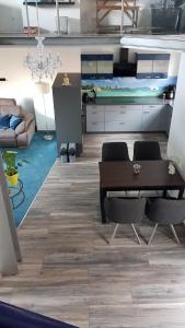 a living room with a wooden table and chairs at FeWo Steingasse in Schwalmstadt