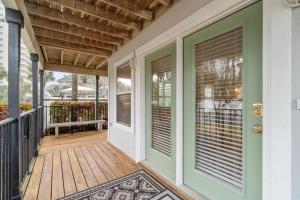 a front porch with a green door and a rug at Serenity Cottage - Spacious Haven - Private Pool in Destin
