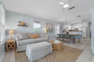 a living room with a couch and a table at Serenity Cottage - Spacious Haven - Private Pool in Destin