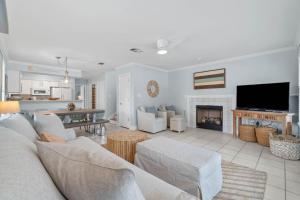 a living room with a couch and a fireplace at Serenity Cottage - Spacious Haven - Private Pool in Destin