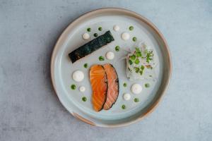 a plate of food with sushi and vegetables on it at The Dunes in Tenby