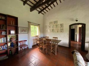 a living room with a dining room table and chairs at Casa Margaret - Hermosa vista a la Sierra in La Cumbre