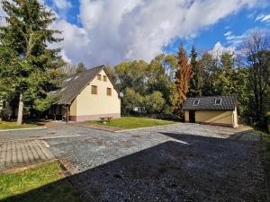 a house with a driveway and a garage at Penzion Mia in Dolní Moravice