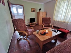 a living room with two chairs and a coffee table at Penzion Mia in Dolní Moravice