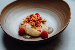 a dessert in a bowl with strawberries on it at The Dunes in Tenby
