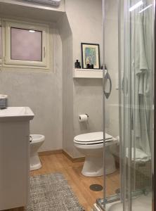 a bathroom with a toilet and a glass shower at Casa Vacanze - Capodimonte - Centro di Napoli in Naples