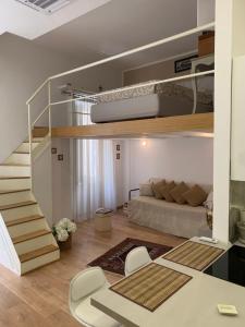 a living room with a bunk bed and a staircase at Casa Vacanze - Capodimonte - Centro di Napoli in Naples