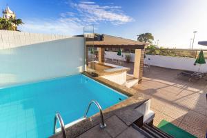 a swimming pool on the roof of a building at Hotel Golden Park Rio de Janeiro Aeroporto in Rio de Janeiro