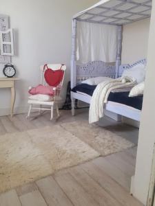 a bedroom with a bed and a chair at B&B Casa della Musica in Vezzano sul Crostolo