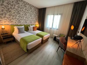 Letto o letti in una camera di Hotel Ben Batouta - Tanger