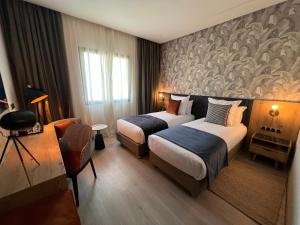 Letto o letti in una camera di Hotel Ben Batouta - Tanger
