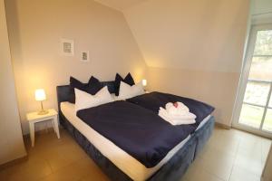 En eller flere senge i et værelse på Ferienhaus Achternkieker