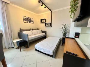 a living room with a bed and a couch at Apto Flat no Morumbi com Vista Incrível ! in Sao Paulo
