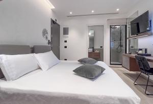 a bedroom with a white bed with two pillows on it at Panorama Hotel Friuli - Boutique Hotel in San Daniele del Friuli