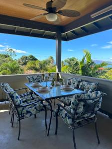 a dining room with a table and chairs and a ceiling fan at Luxurious Home in Wailea in Wailea