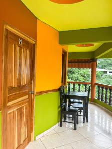 a dining room with a table and chairs on a balcony at Hostal Familiar Rolo in Santa Catalina