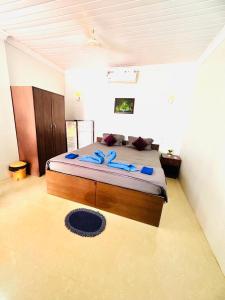um quarto com uma cama grande e toalhas azuis em Blue Mirage Palolem Goa em Canacona