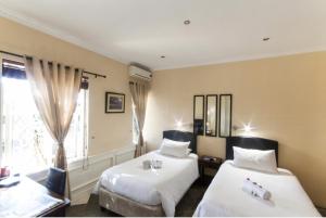 Ένα ή περισσότερα κρεβάτια σε δωμάτιο στο Sunbell Ventures Guesthouse +36 φωτογραφίες