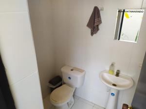 a small bathroom with a toilet and a sink at Casa Almendros in Cartagena de Indias