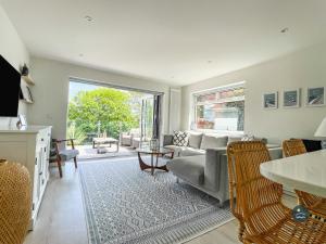 Seafeathers - Luxury Holiday Home with Sea Views في Overcombe: غرفة معيشة مع أريكة وطاولة