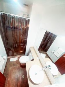 a bathroom with two toilets and a shower and a mirror at HOTEL TEUSAQUILLO BOUTIQUE BOGOTA in Bogotá +19 photos