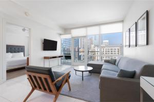 a living room with a couch and a bed at Level Los Angeles - Downtown South Olive in Los Angeles