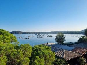 a view of a lake with boats in the water at Hôtel du Golfe Pinarello in Pinarellu