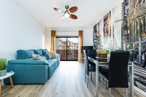 a living room with a blue couch and a table at Dream Nest in Armação de Pêra