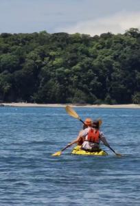 two people in a kayak on a body of water at Hostal Familiar Rolo in Santa Catalina