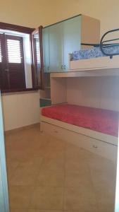 a room with a bunk bed and a window at Vittorio house -Villetta indipendente - Villasimius in Villasimius