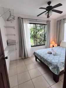 a bedroom with a bed and a window at Hotel Villas de la Colina in Atenas