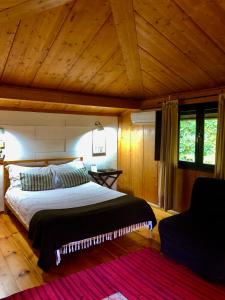 a bedroom with a large bed in a room with wooden ceilings at Quinta Lamosa Agroturismo in Arcos de Valdevez